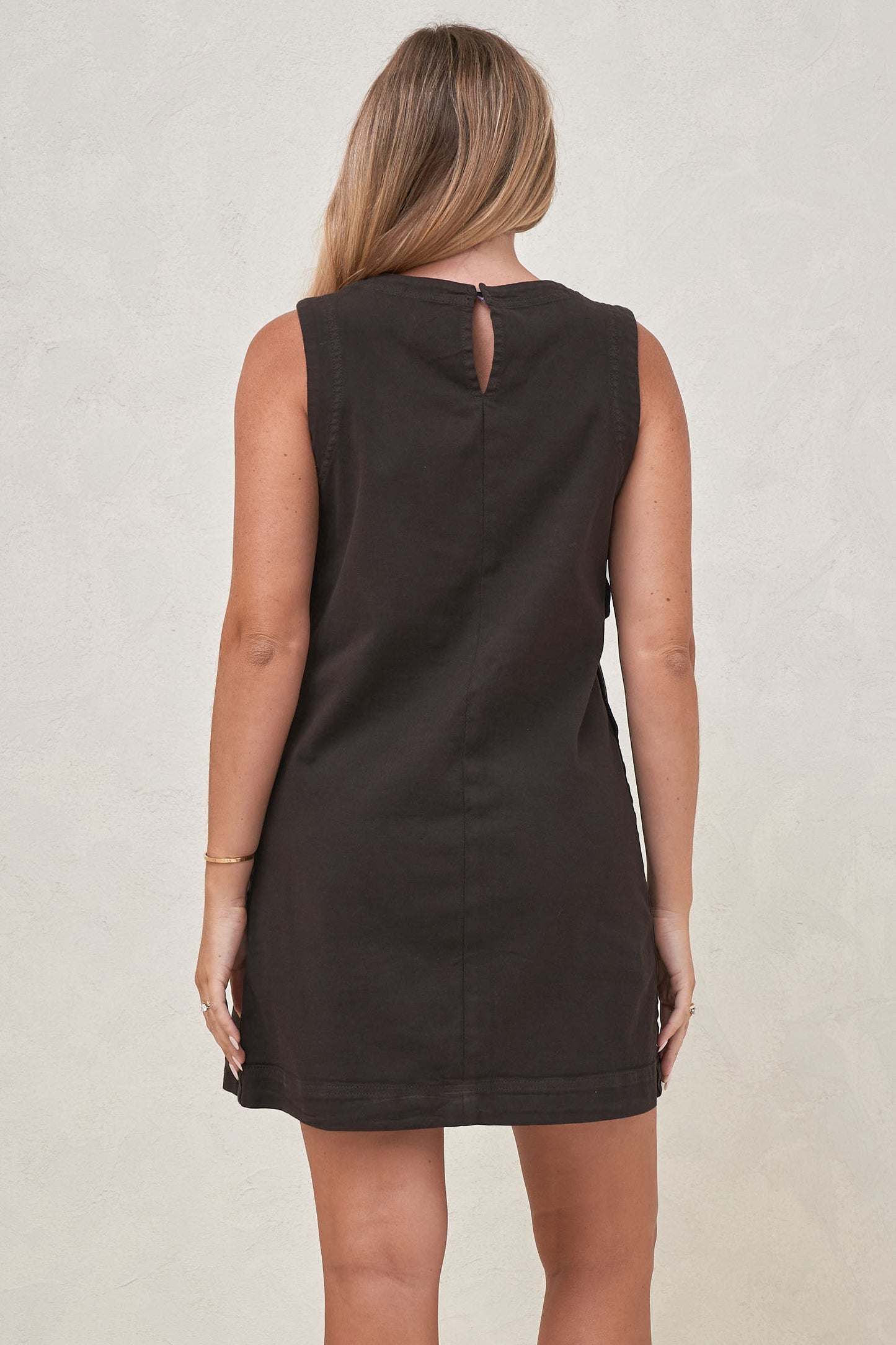 Back view of a pregnant women wearing maternity snap side dress in chocolate  