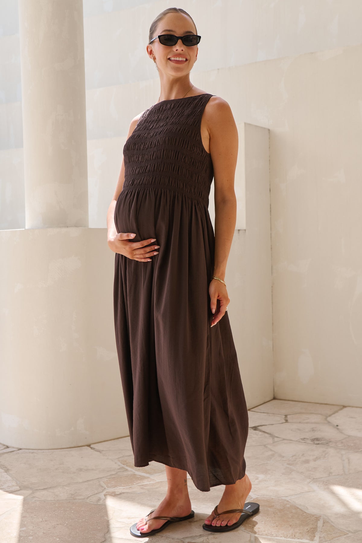 Maternity maxi dress in brown – side view showing bump and gathered skirt