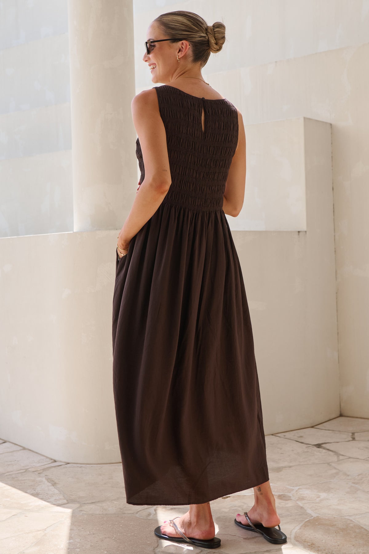 Maternity maxi dress in brown – back view with button keyhole and shirred bodice