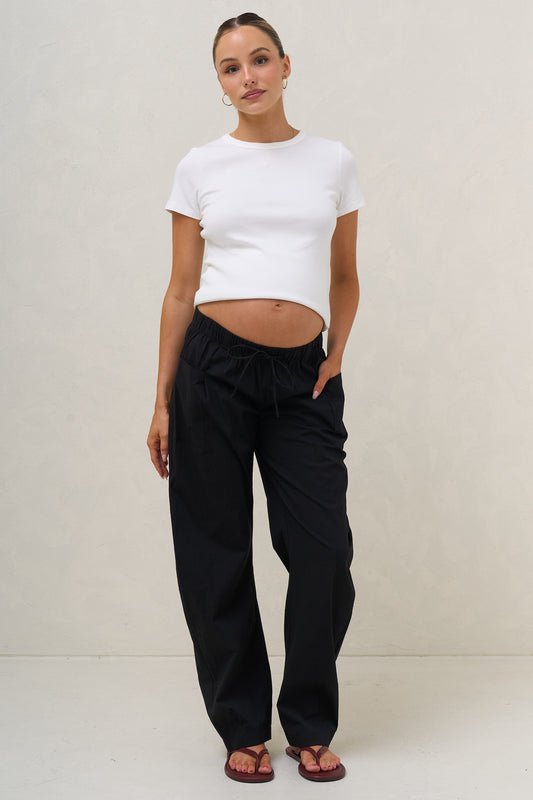 Maternity barrel pants in black – front view with drawcord waist under bump