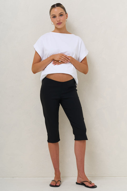Maternity capri pants in black – front view with white tee