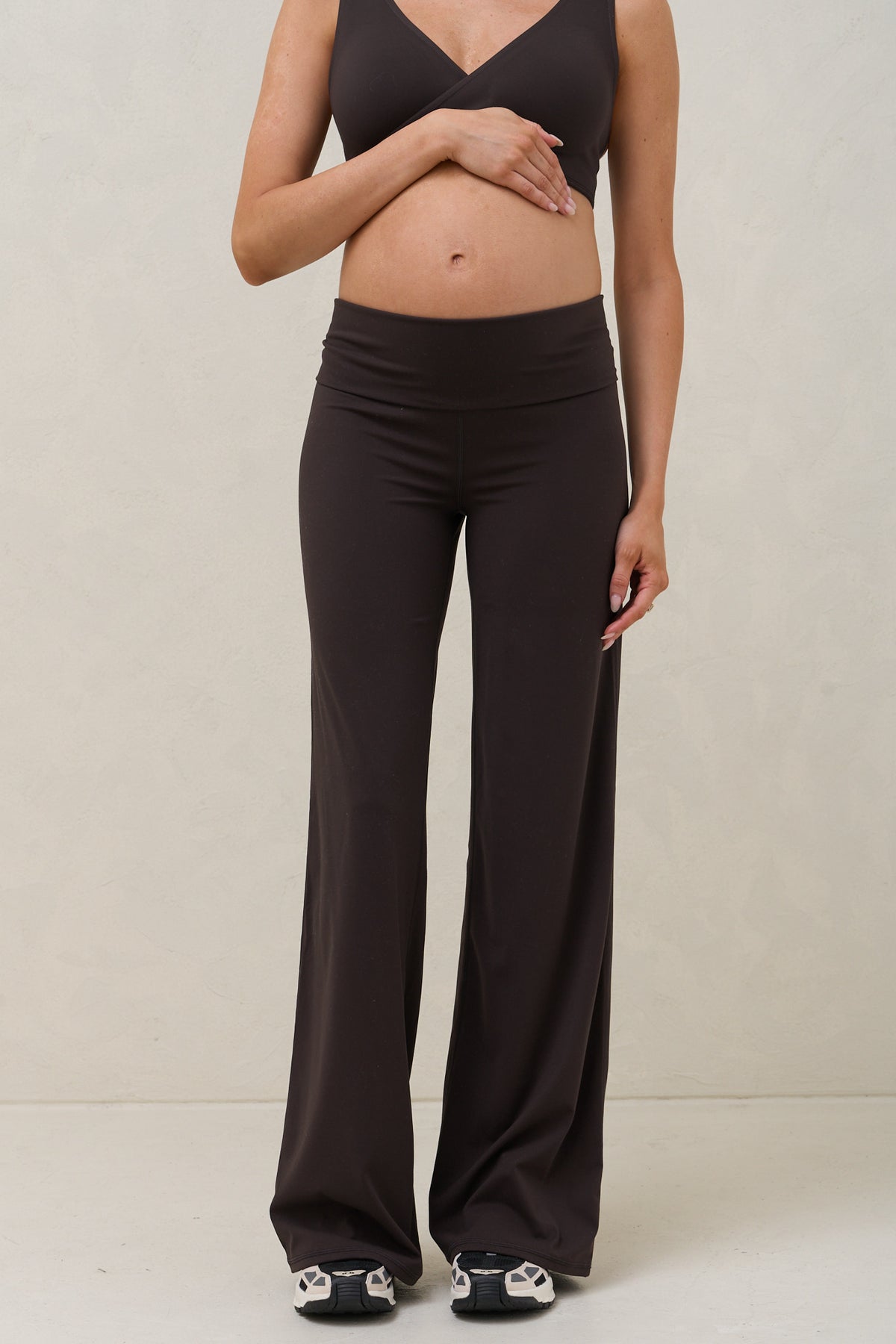 Maternity wide leg leggings in brown – front view with waistband folded under bump