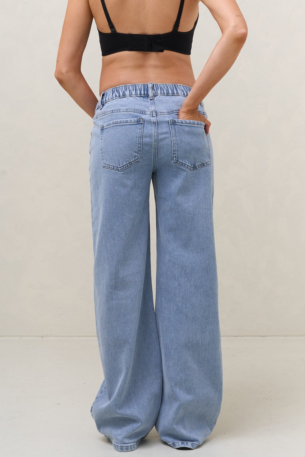 Baggy wide leg maternity jeans in blue – back view, full length