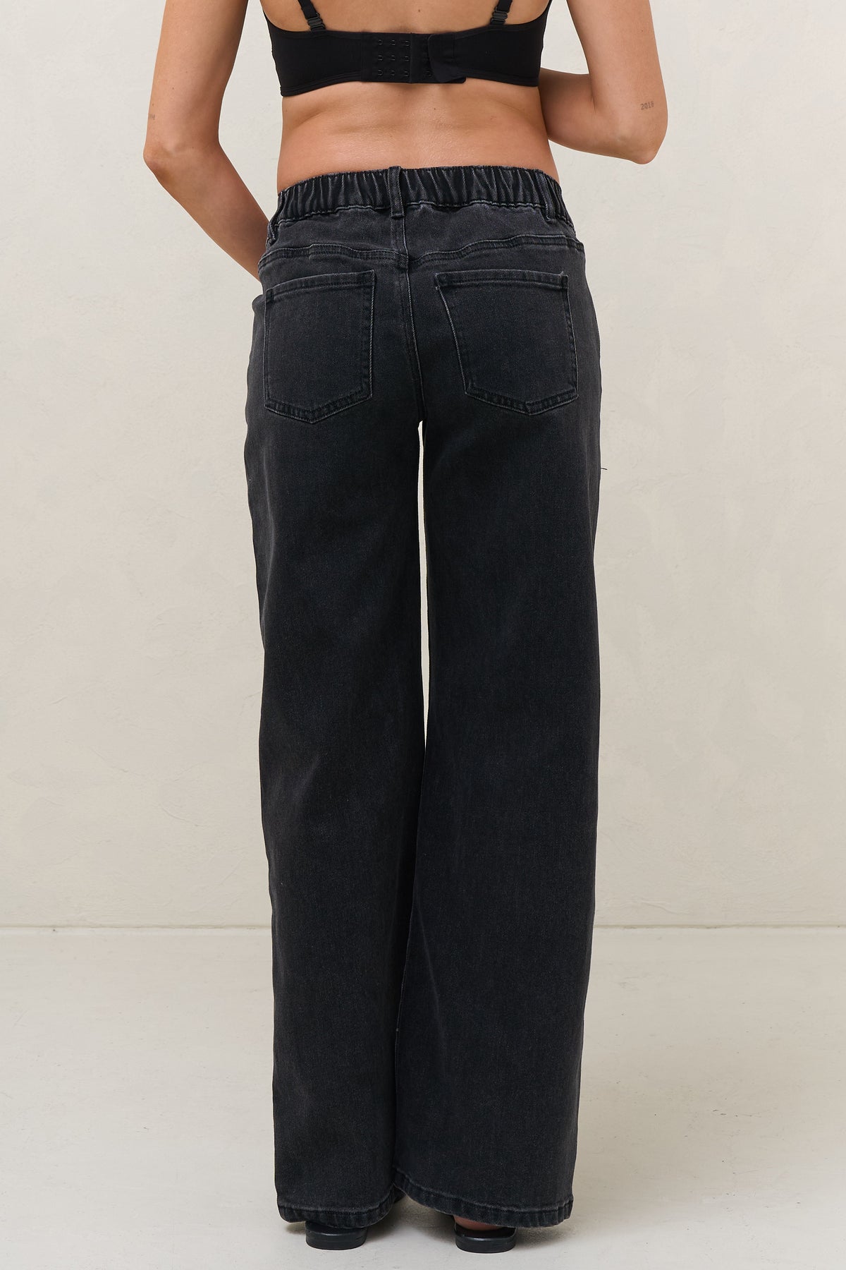 Baggy wide leg maternity jeans in black – back view, full length